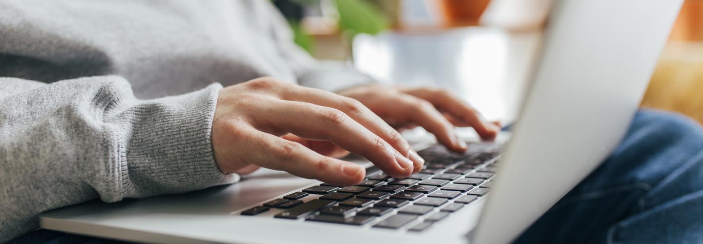 Focused Work: Hands Typing on a Laptop
