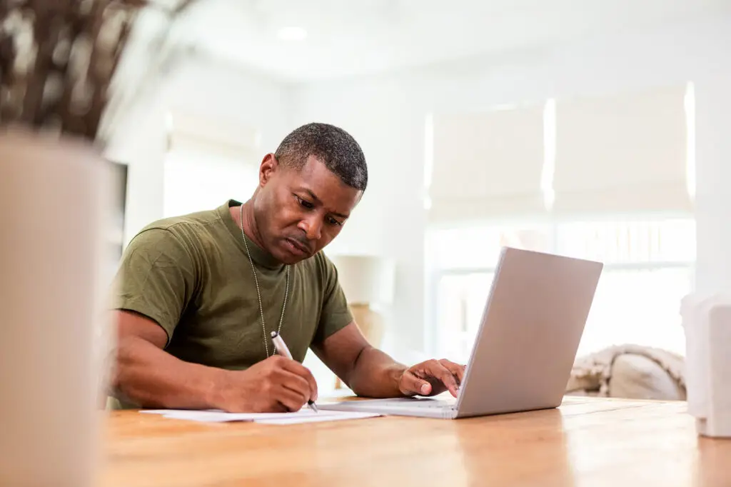 Serious mature soldier continues education online.